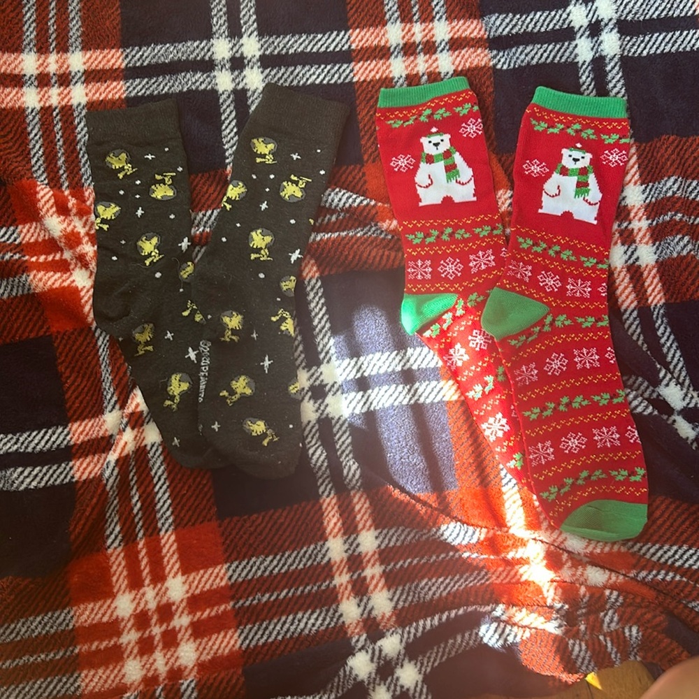 Two pairs of sock Christmas themed and peanut movie themed